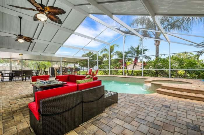 a pool with a hot tub and a patio area