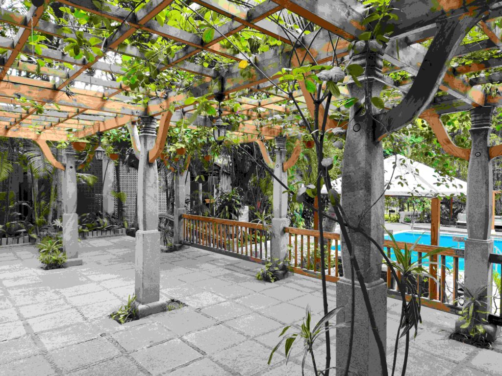 a patio with a pergola and a pool