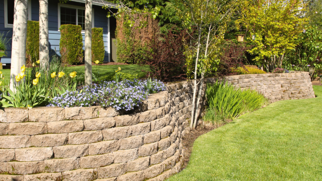 A retaining wall in a garden setting, surrounded by colorful flowers enhancing the outdoor space in Lakeland, FL