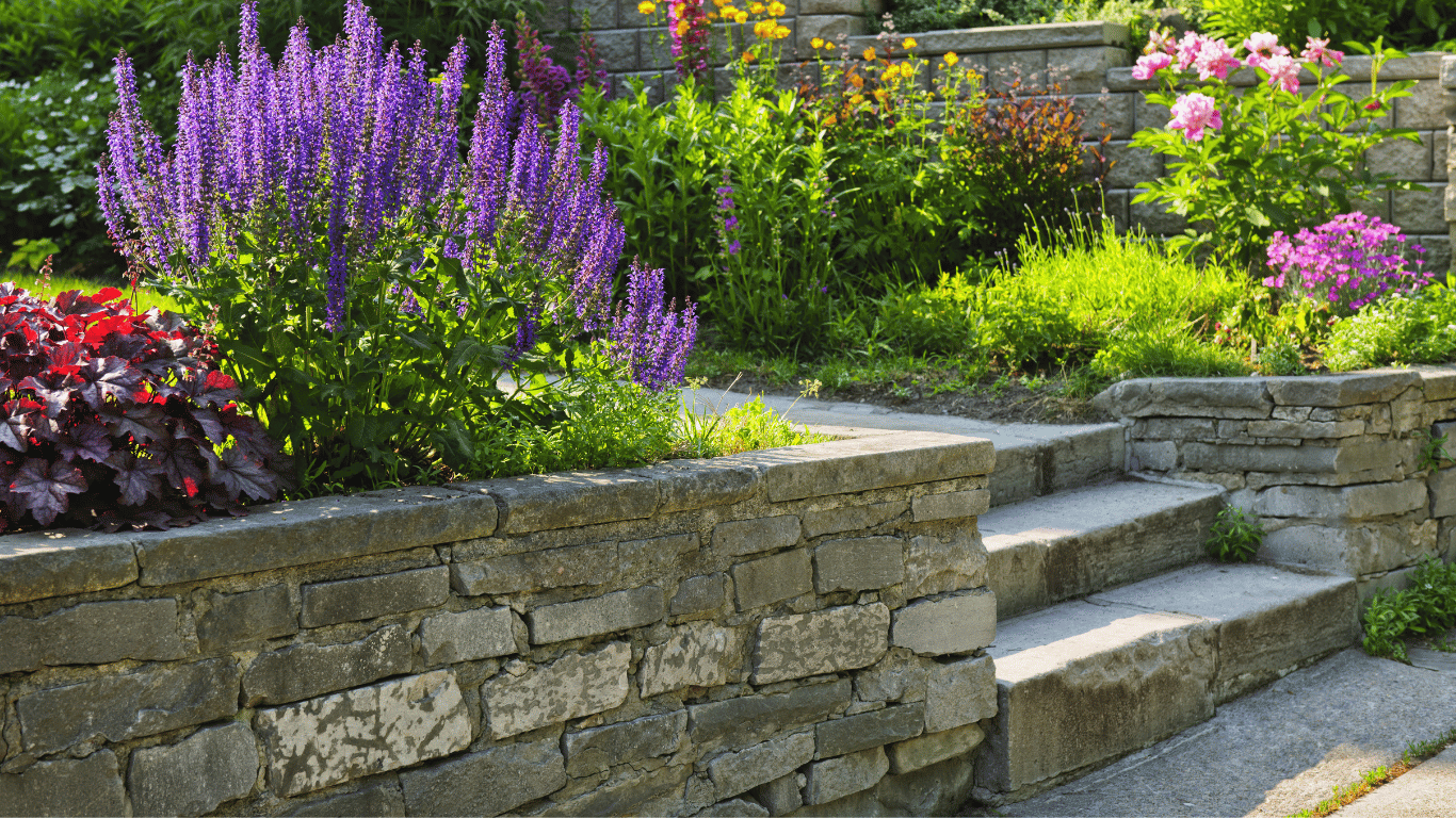 A vibrant stone wall adorned with colorful flowers and lush plants, showcasing the beauty of nature and design in Lakeland, FL